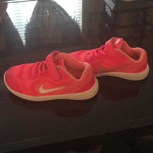 Little girls pink and white Nike shoes.